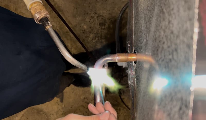 a person welding a pipe